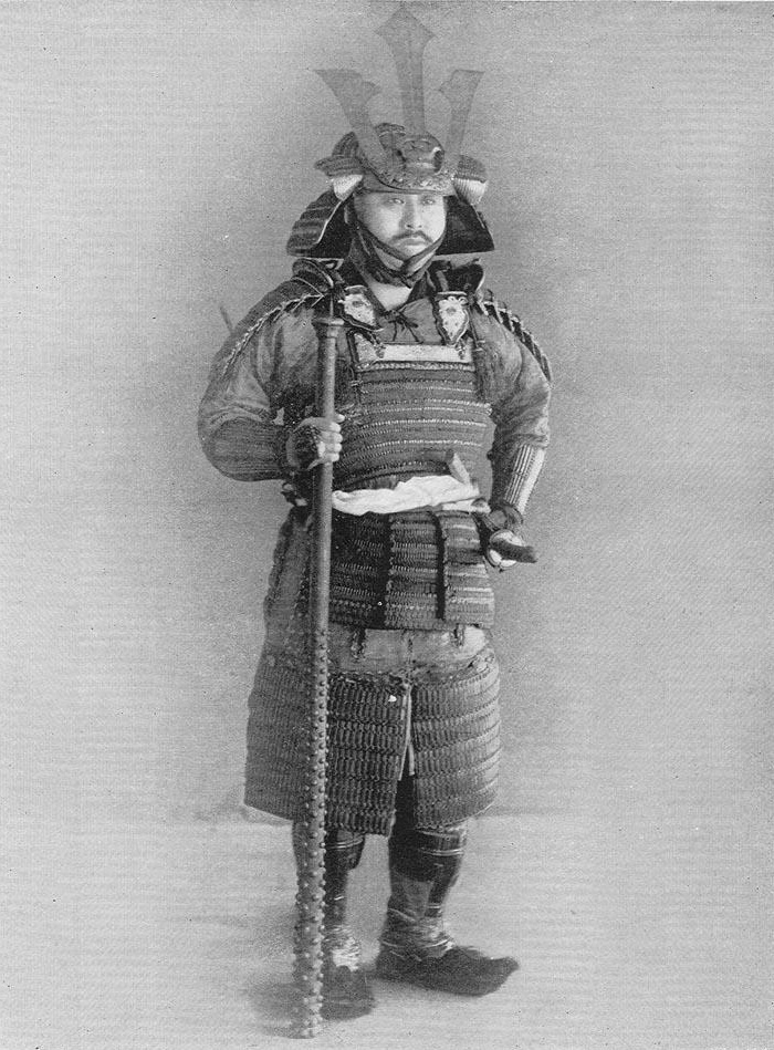 A samurai in full armor from the Nanboku-cho period, illustrated in Military Costumes in Old Japan (1893)